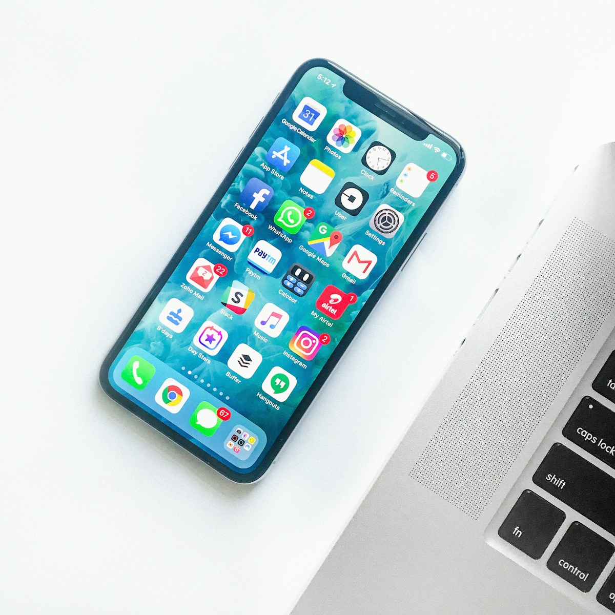 Smartphone and laptop on a desk